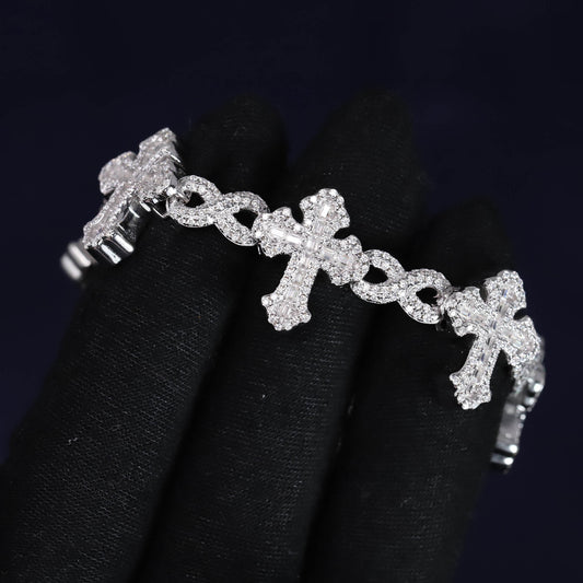 Silver bracelet with cross designs on a black background