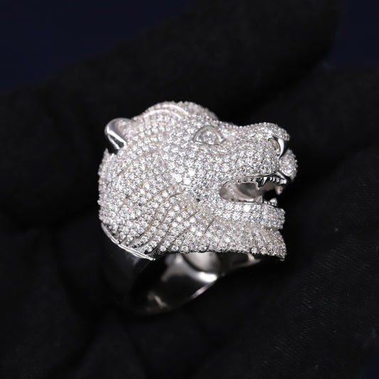 Silver panther head ring with gemstones on a black background