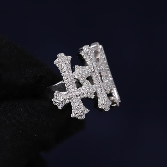 Silver ring with letter 'H' design on a black background