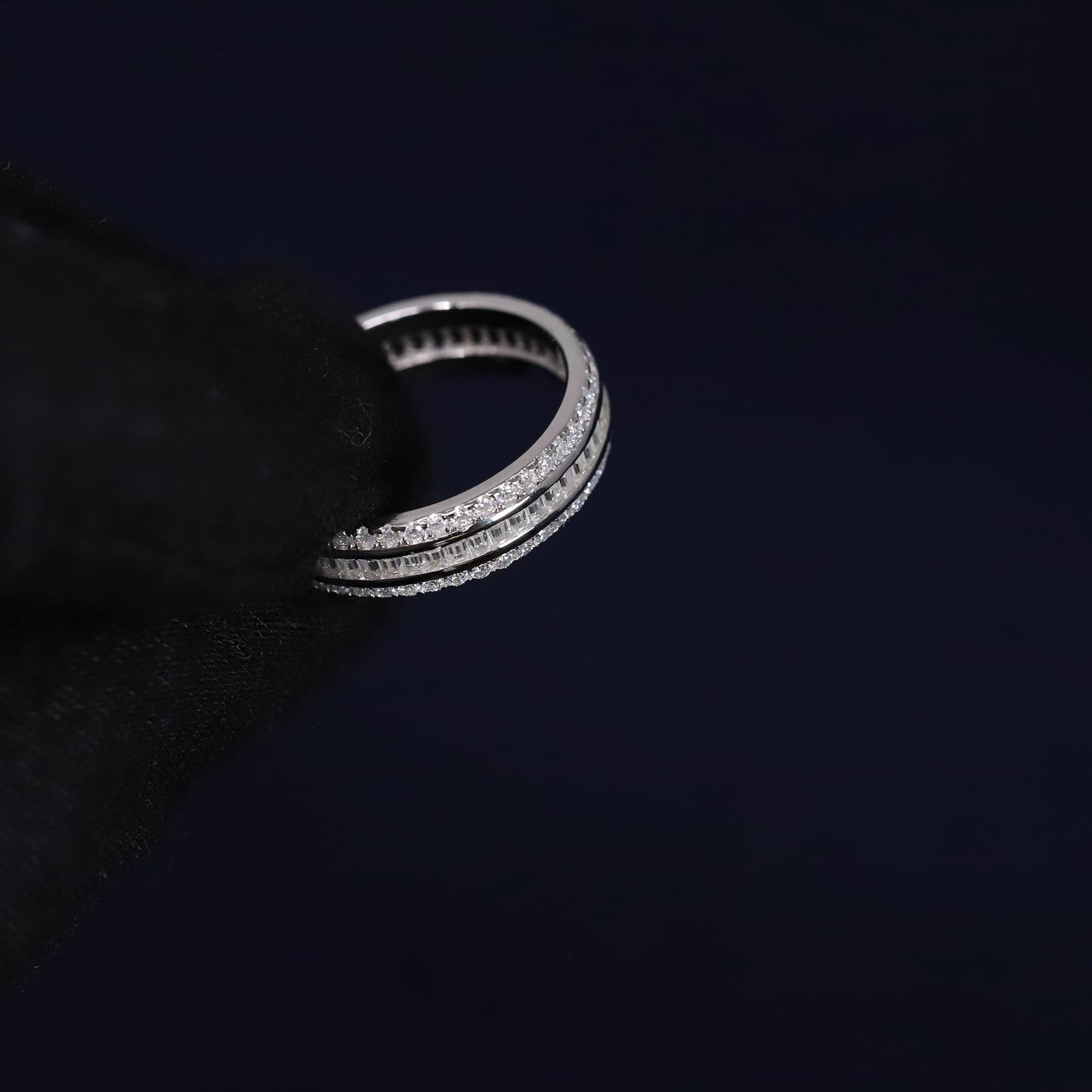 Silver ring with multiple bands on a black background