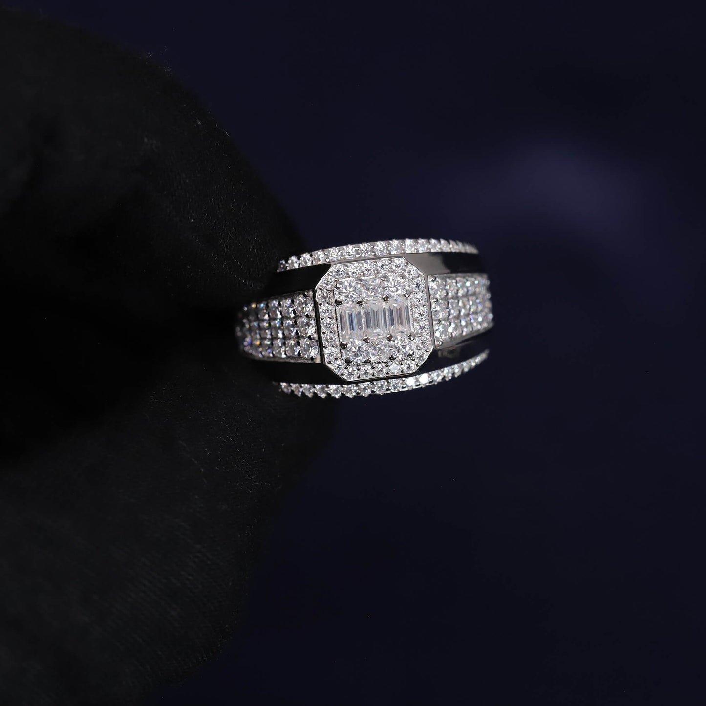 Silver ring with gemstones on a dark background