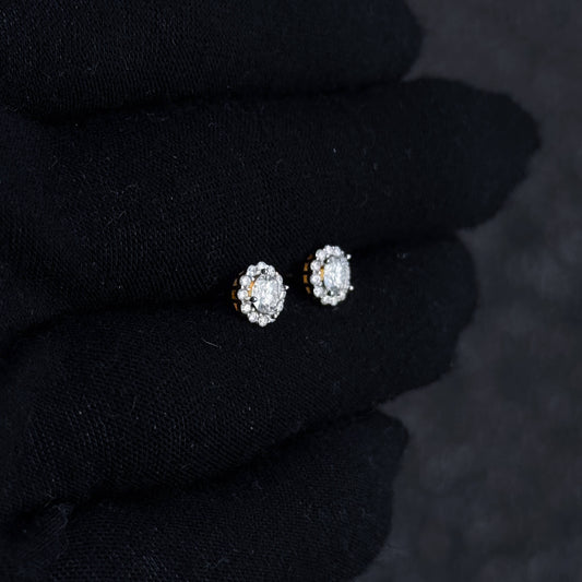 Small 7mm Moissanite cluster diamond stud earrings shown on black glove in sterling silver setting.