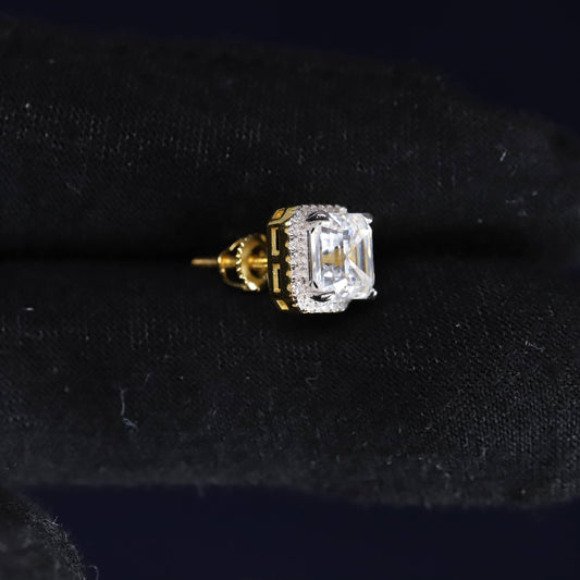 Gold and diamond earring on a black velvet background