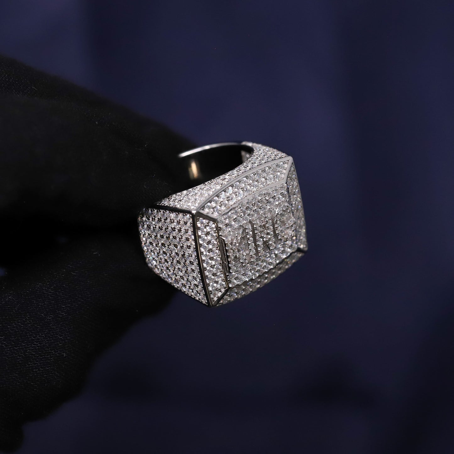 Silver ring with gemstones on a dark background