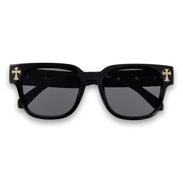 Black sunglasses with gold accents on a white background