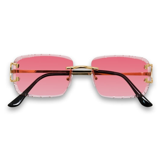 Sunglasses with pink lenses and gold frames on a white background
