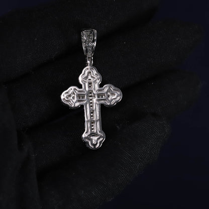 Silver cross pendant on a black background