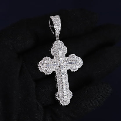 Silver cross pendant with clear stones on a black background