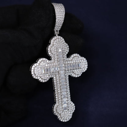 Silver cross pendant with gemstones on a dark background