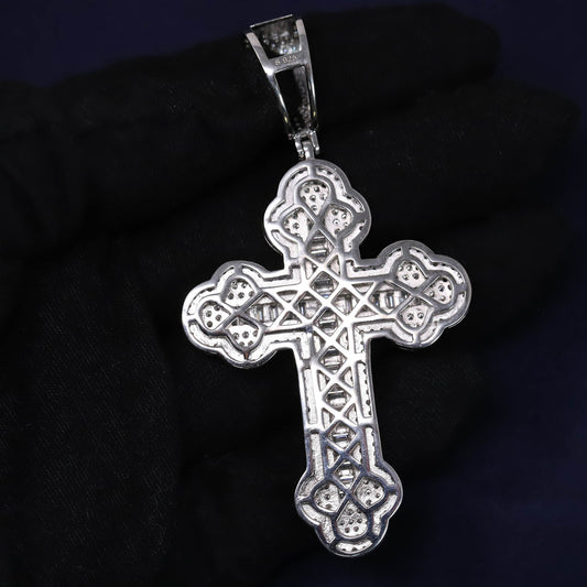 Silver cross pendant on a dark background