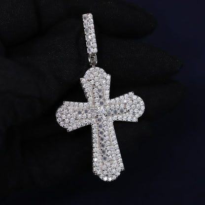 Silver cross pendant with clear stones on a black background