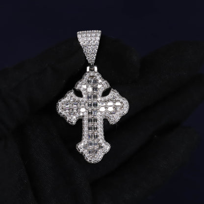 Silver cross pendant with clear stones on a black background