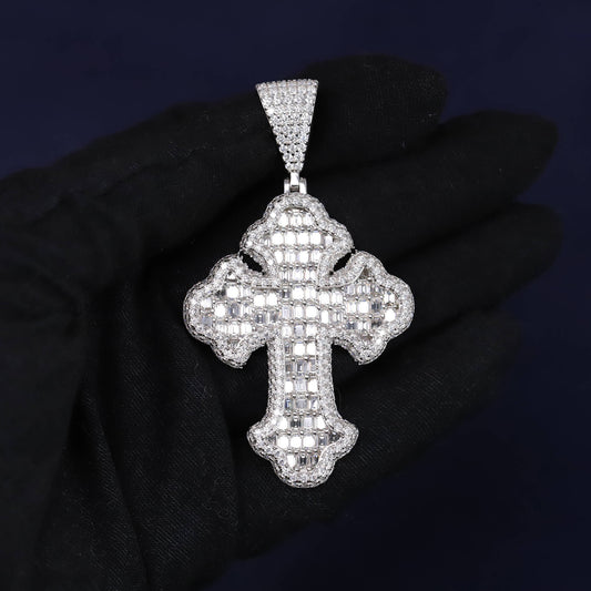 Silver cross pendant with clear stones on a dark background