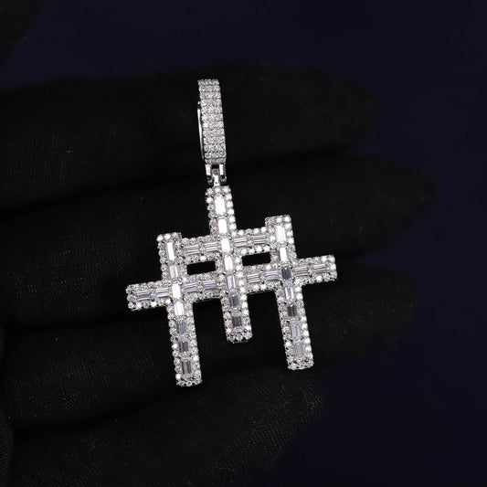 Silver cross pendant with clear stones on a black background