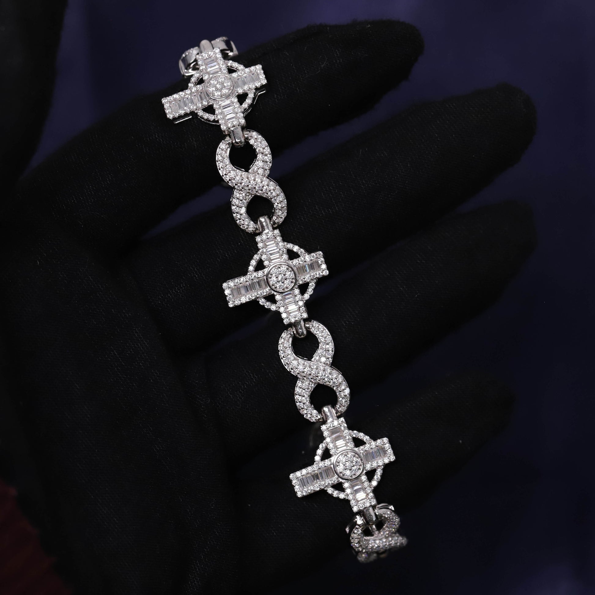 Silver bracelet with cross designs on a dark background