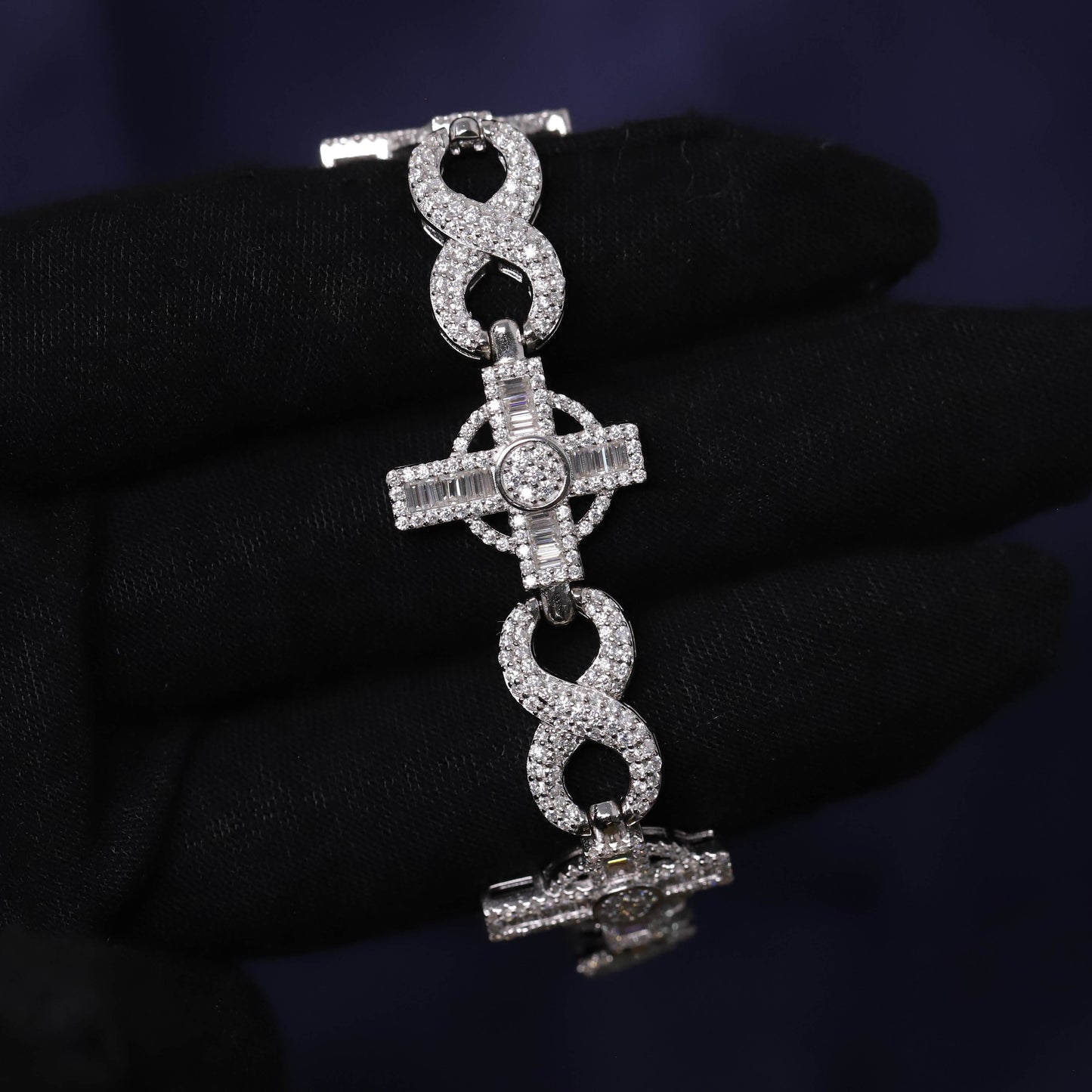 Silver bracelet with intricate design on a dark background