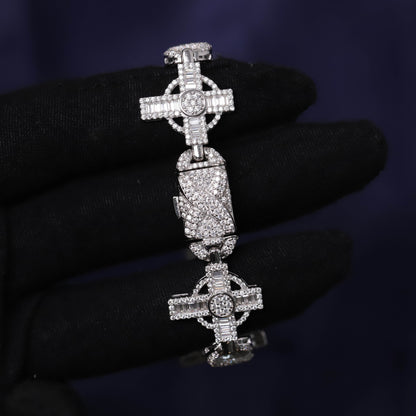 Silver cross pendant with gemstones on a dark background