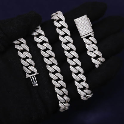 Set of silver braided bracelets on a dark background