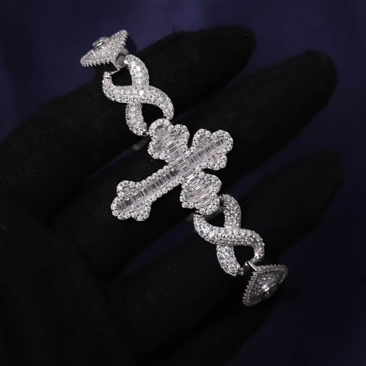 Silver earring with intricate design on a dark background