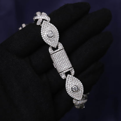 Silver bracelet with diamond accents on a black glove against a dark background