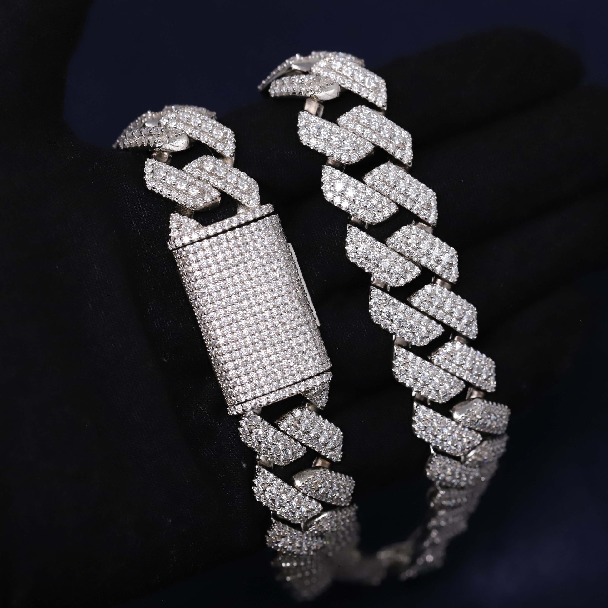 Silver chain bracelet with diamond-like stones on a dark background