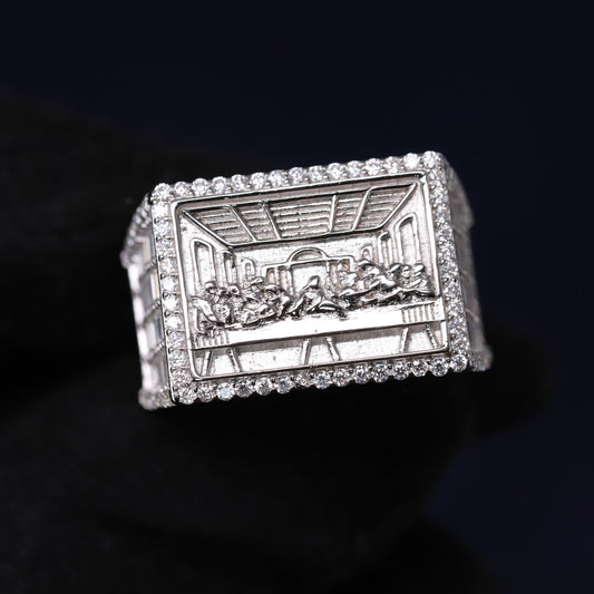 Silver ring with engraved design on a black background