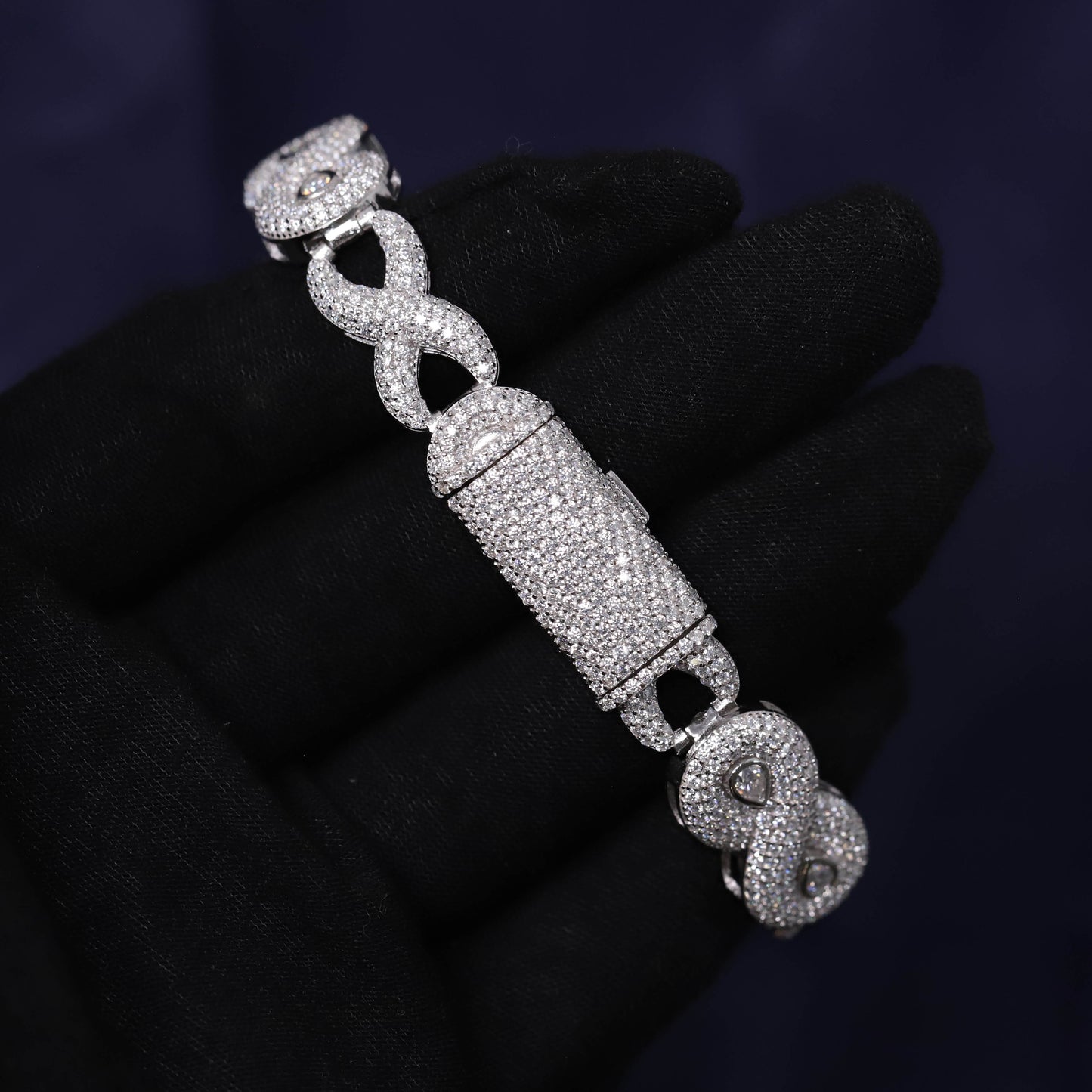 Silver bracelet with intricate design on a dark background