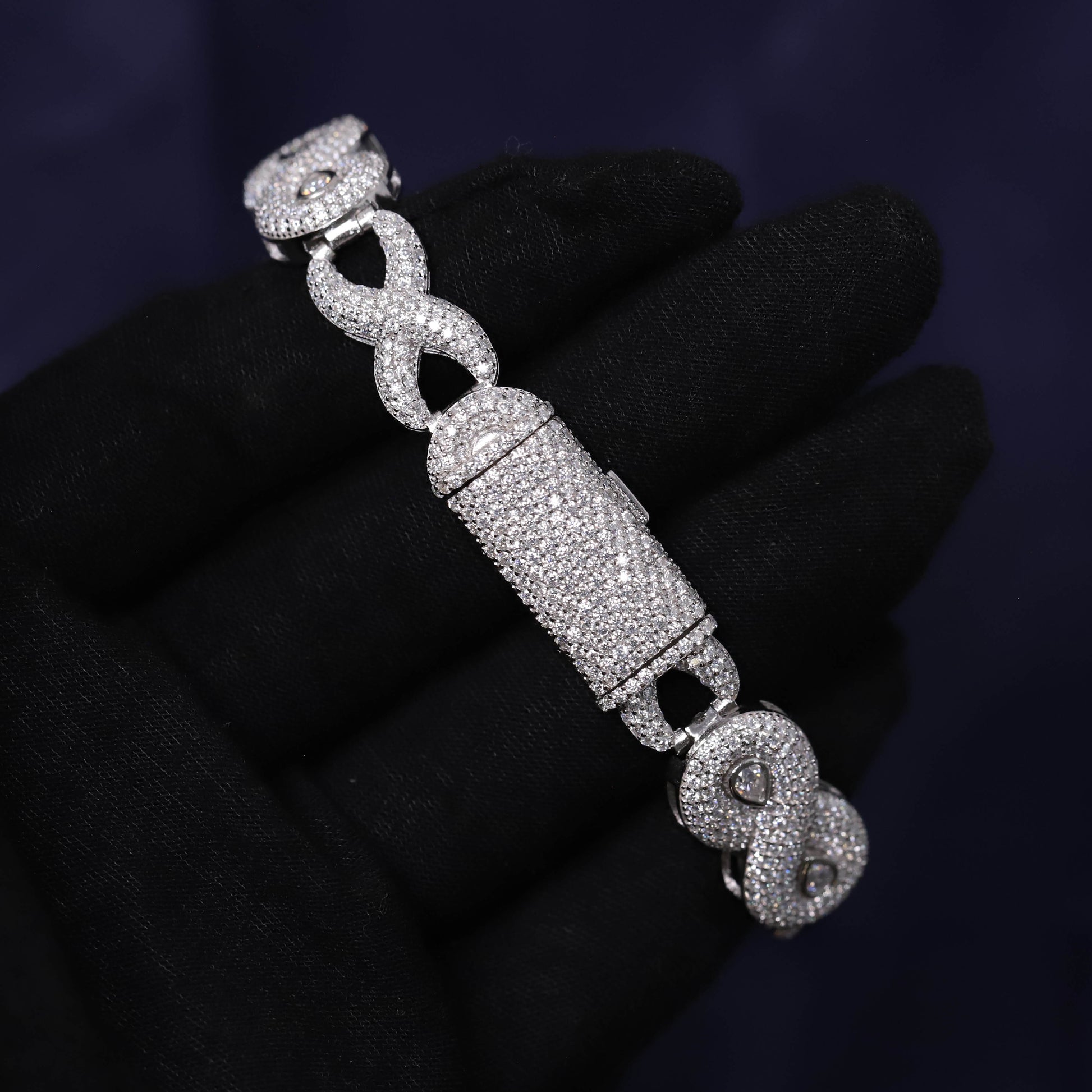 Silver bracelet with intricate design on a dark background