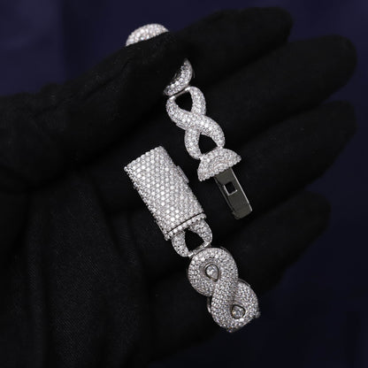 Silver jewelry set with bell and infinity design on a dark background