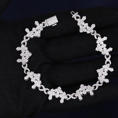 Silver bracelet with floral design on a black fabric background