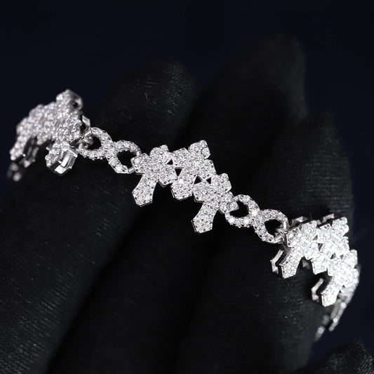 Silver bracelet with floral designs on a dark background