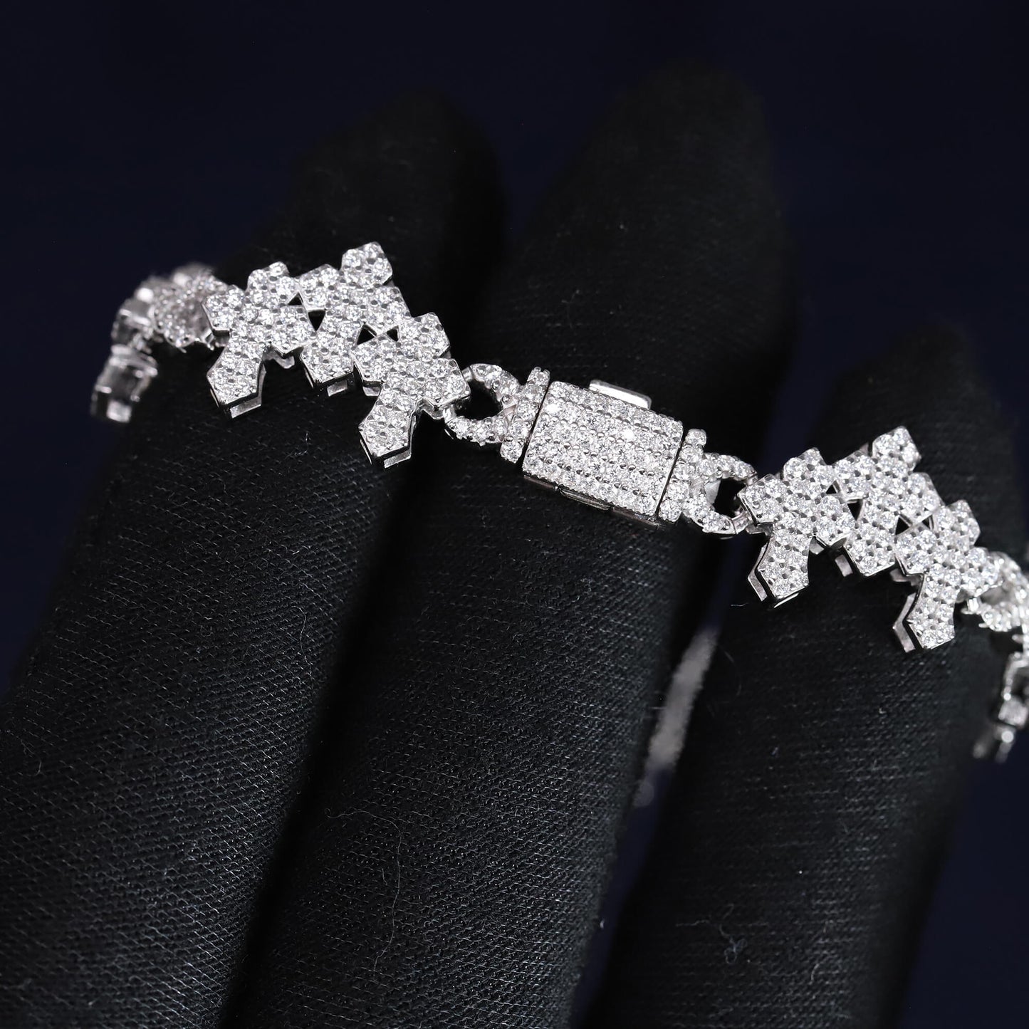 Silver bracelet with diamond accents on a black background