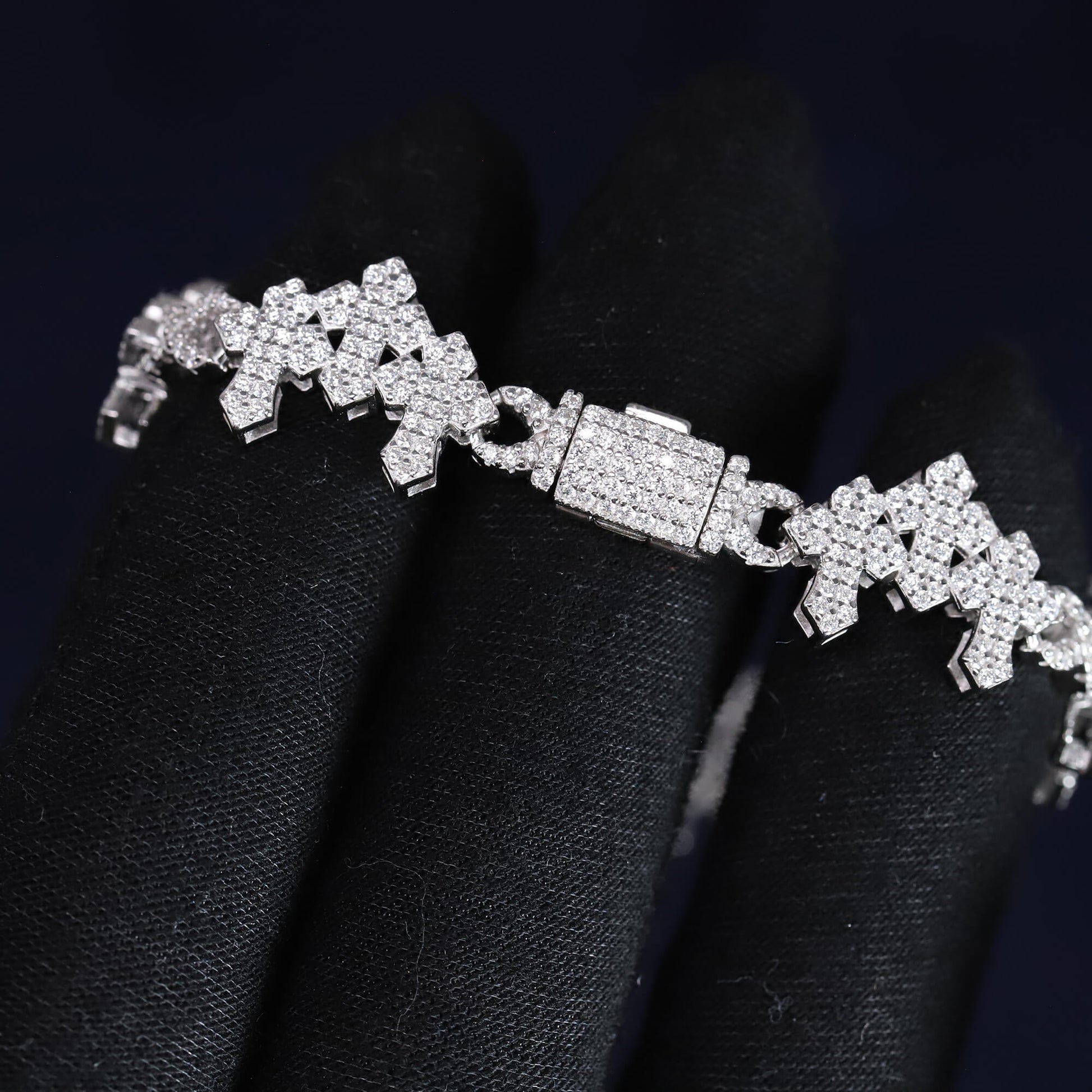 Silver bracelet with diamond accents on a black background