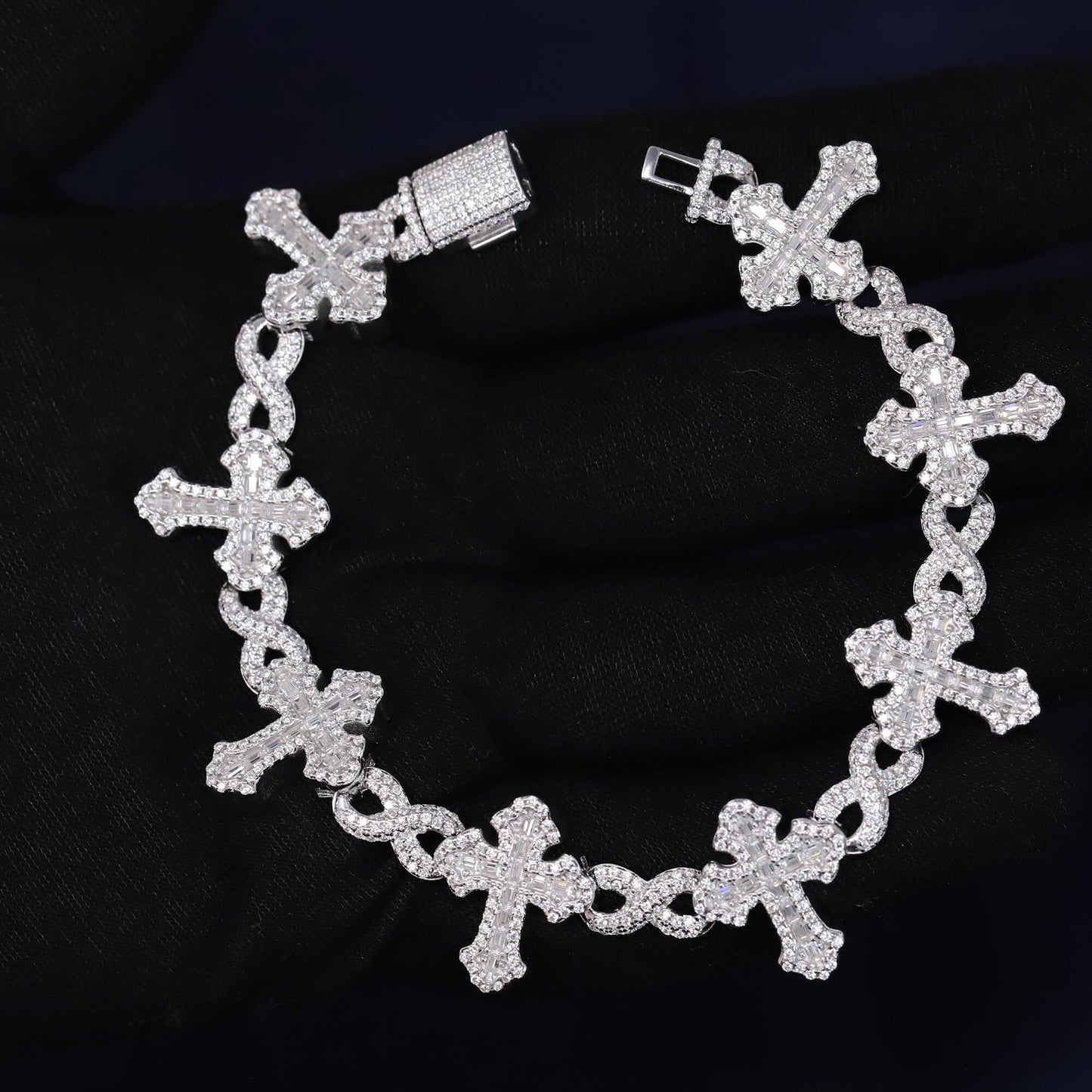 Silver bracelet with cross designs on a black background