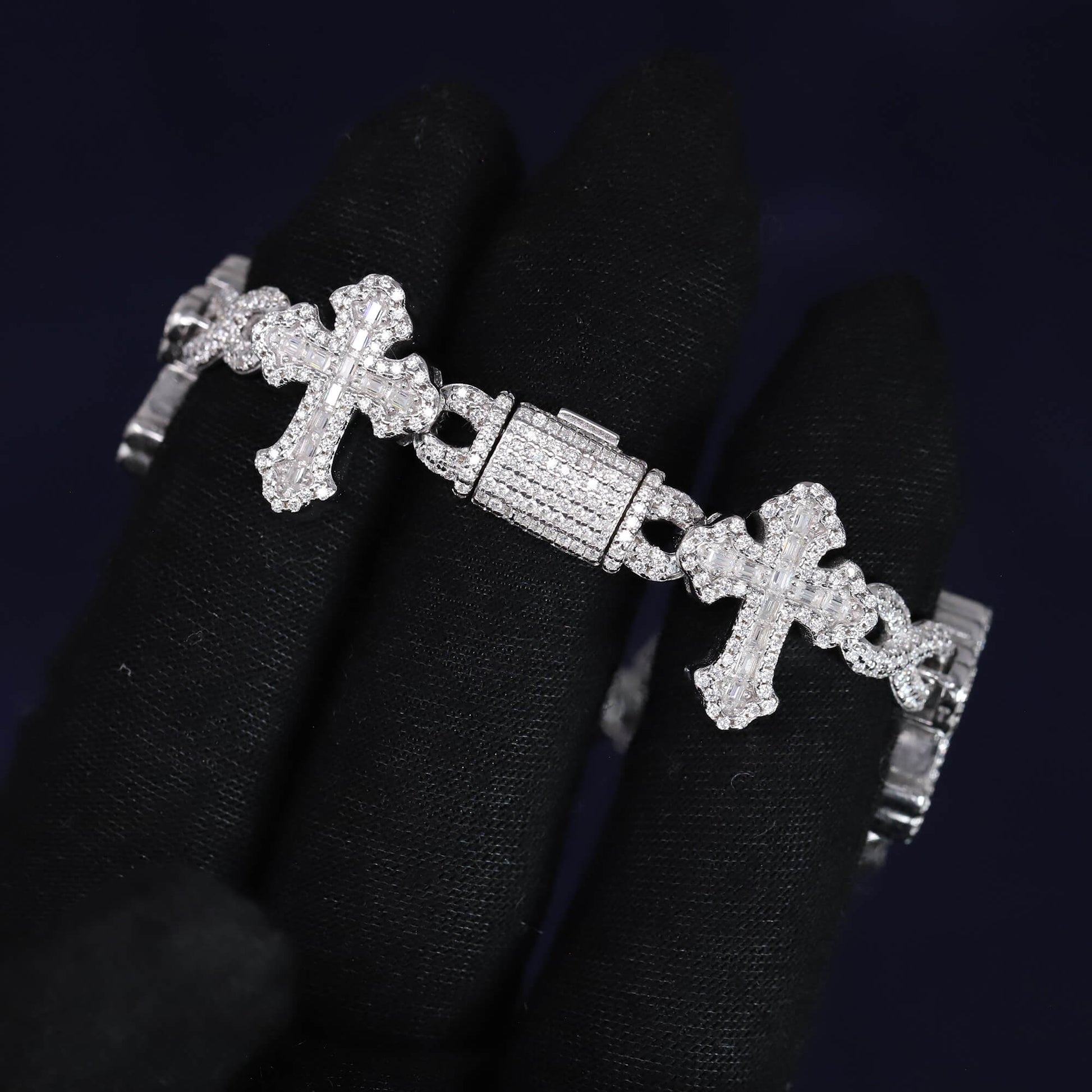 Silver bracelet with cross designs on a black background