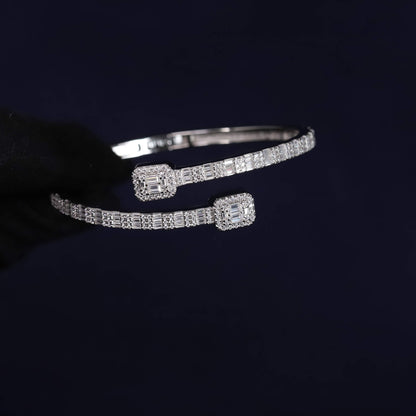 Silver bracelet with diamond accents on a dark background