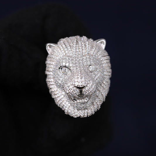 Silver lion head sculpture on a black background