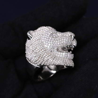 Silver panther head ring with gemstones on a black background