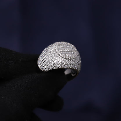 Silver ring with intricate design on a dark background