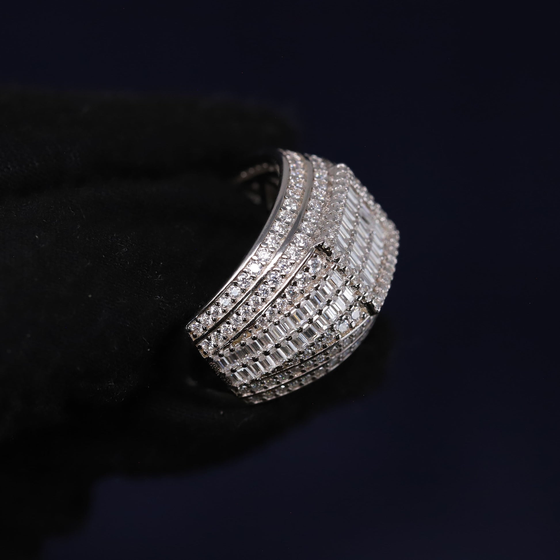 Silver bracelet with clear stones on a black background