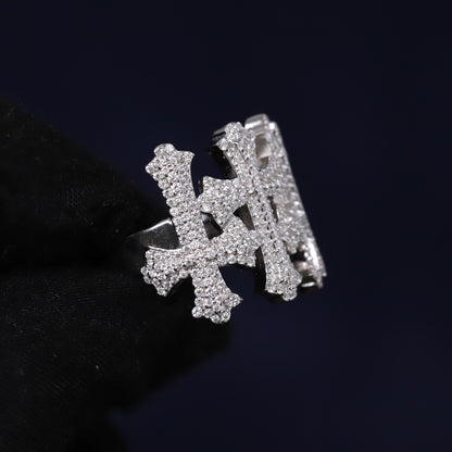 Silver ring with letter 'H' design on a black background