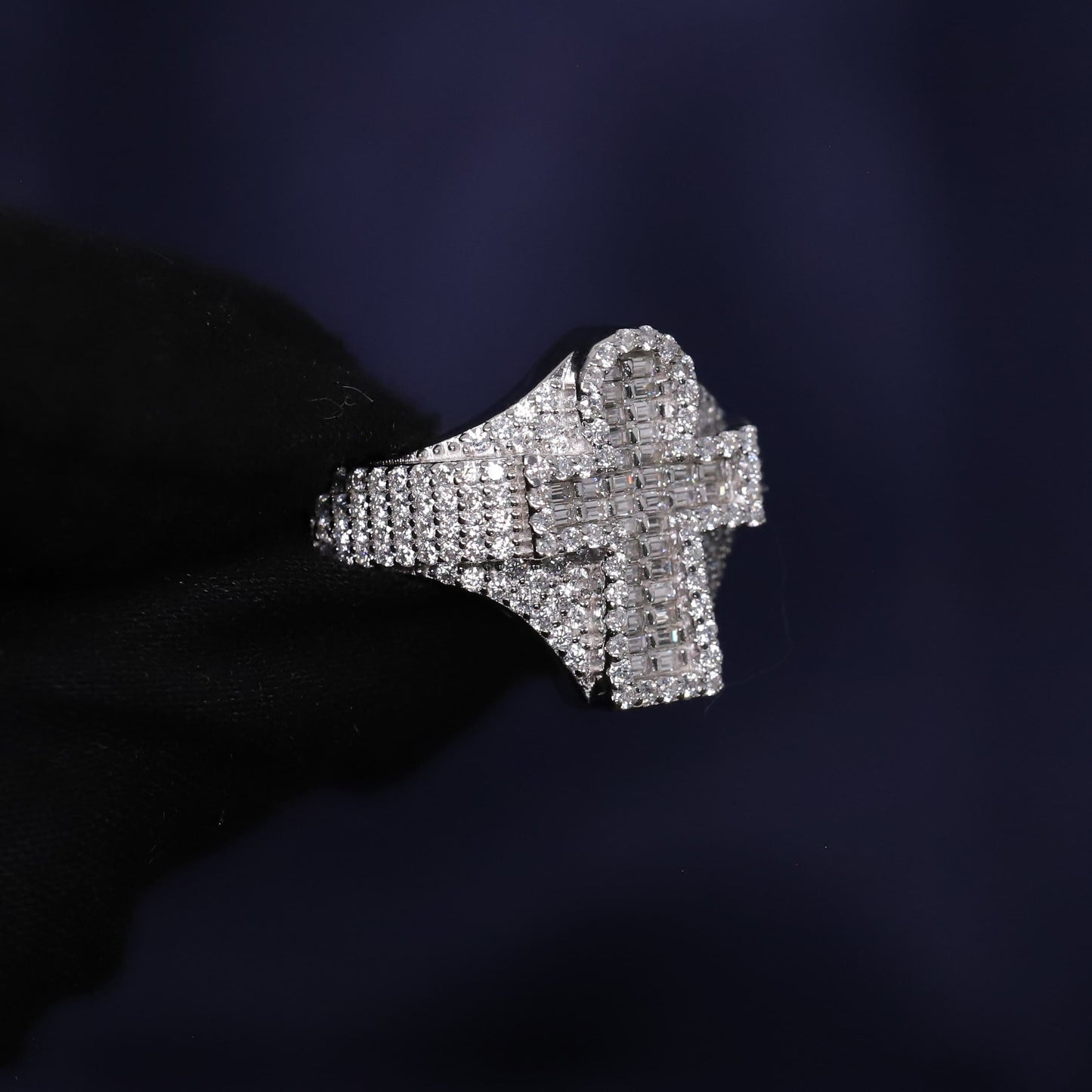 Silver ring with diamond accents on a dark background