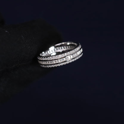 Three silver rings stacked on a black surface