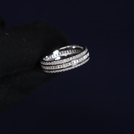 Three silver rings stacked on a black surface