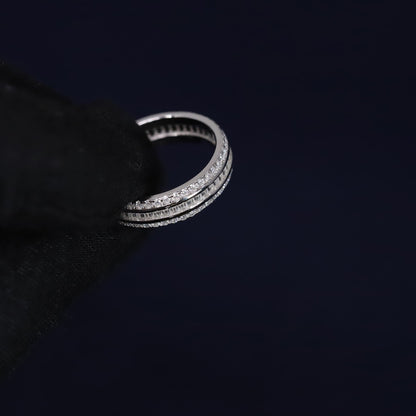 Silver ring with multiple bands on a black background