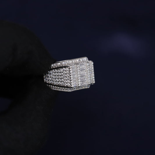 Silver ring with multiple diamond settings on a dark background
