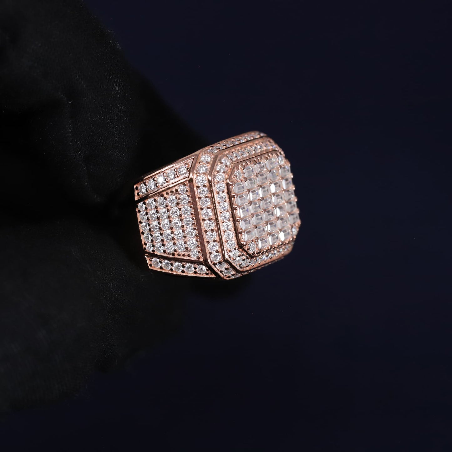 Rose gold ring with diamond accents on a black background