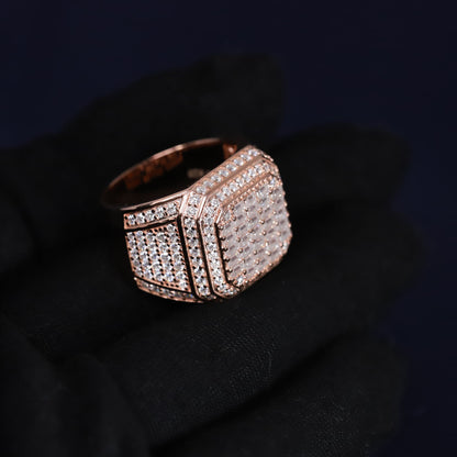 Rose gold ring with diamond accents on a dark background