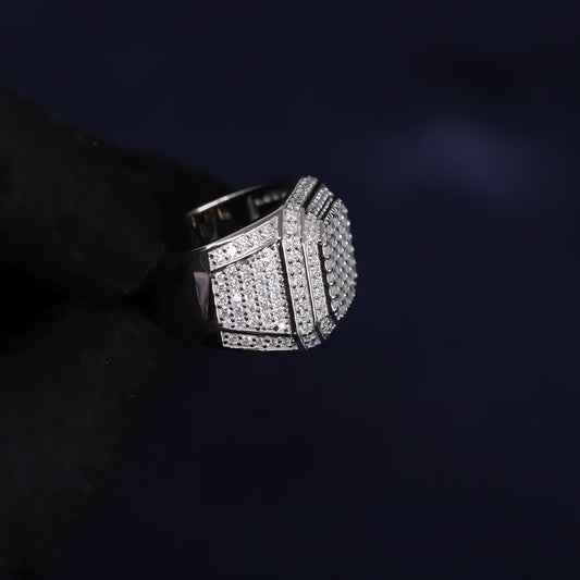 Silver ring with diamond accents on a dark background