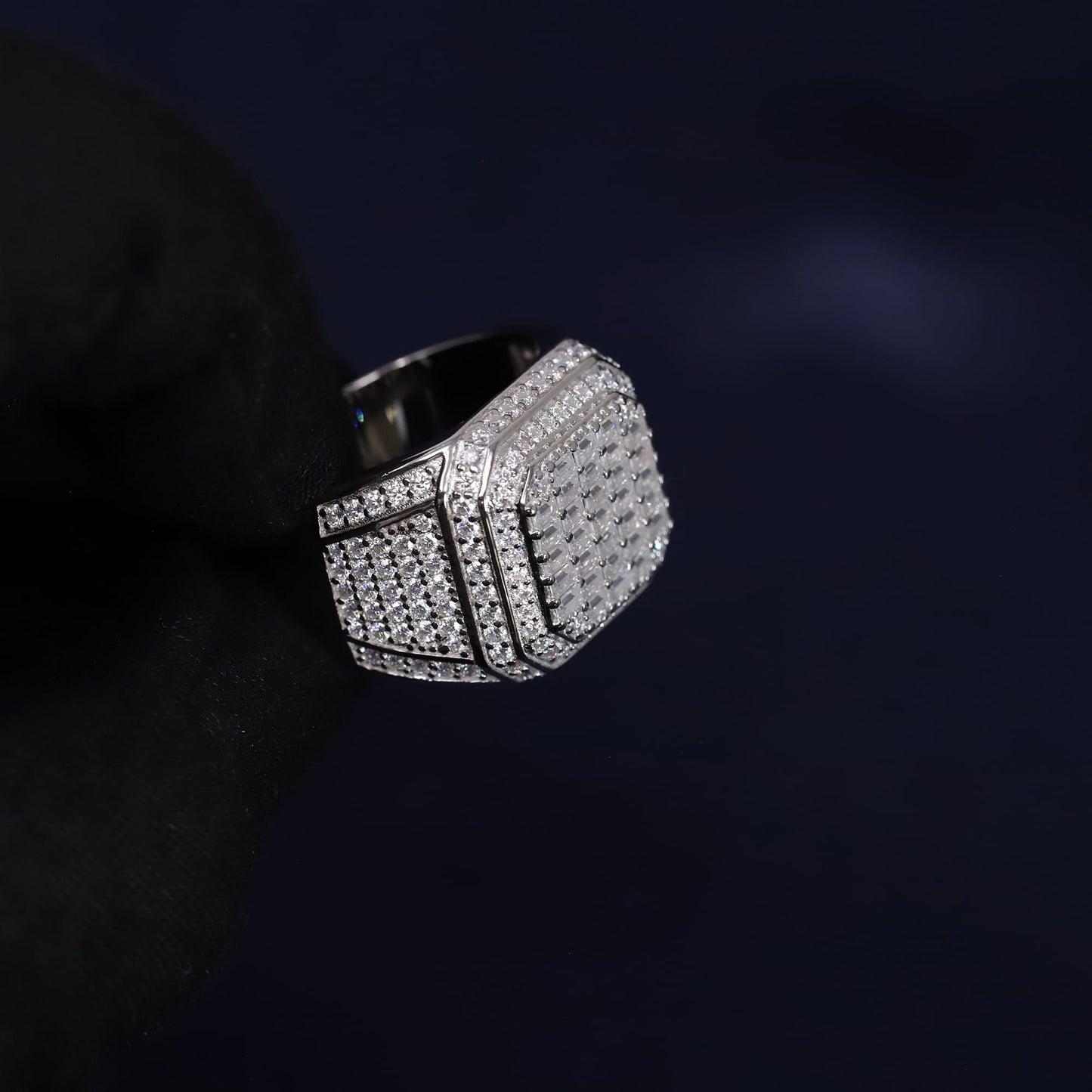 Silver ring with gemstones on a dark background